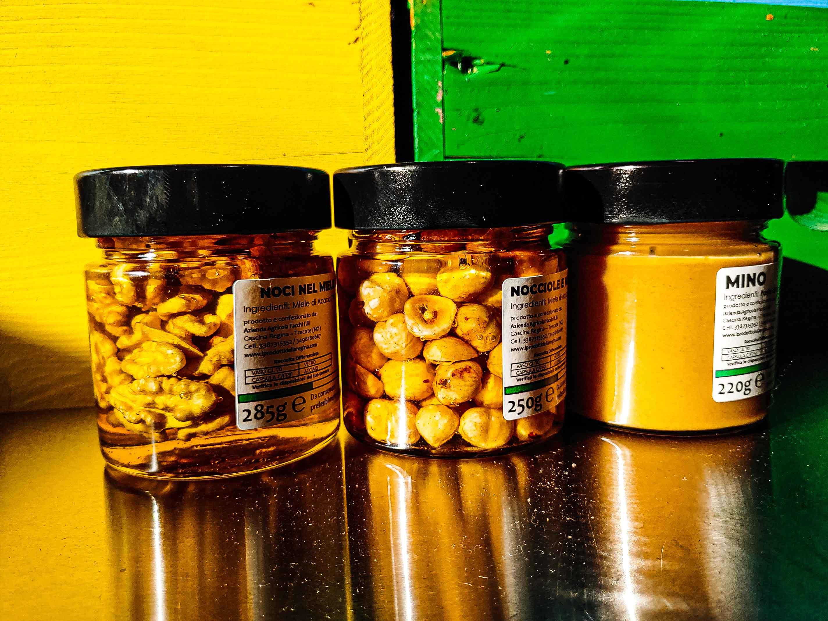Tre vasetti di miele con noci, nocciole e crema di miele su sfondo giallo e verde, C'era Una Volta - Bottega delle Mucche - Trecate (NO)